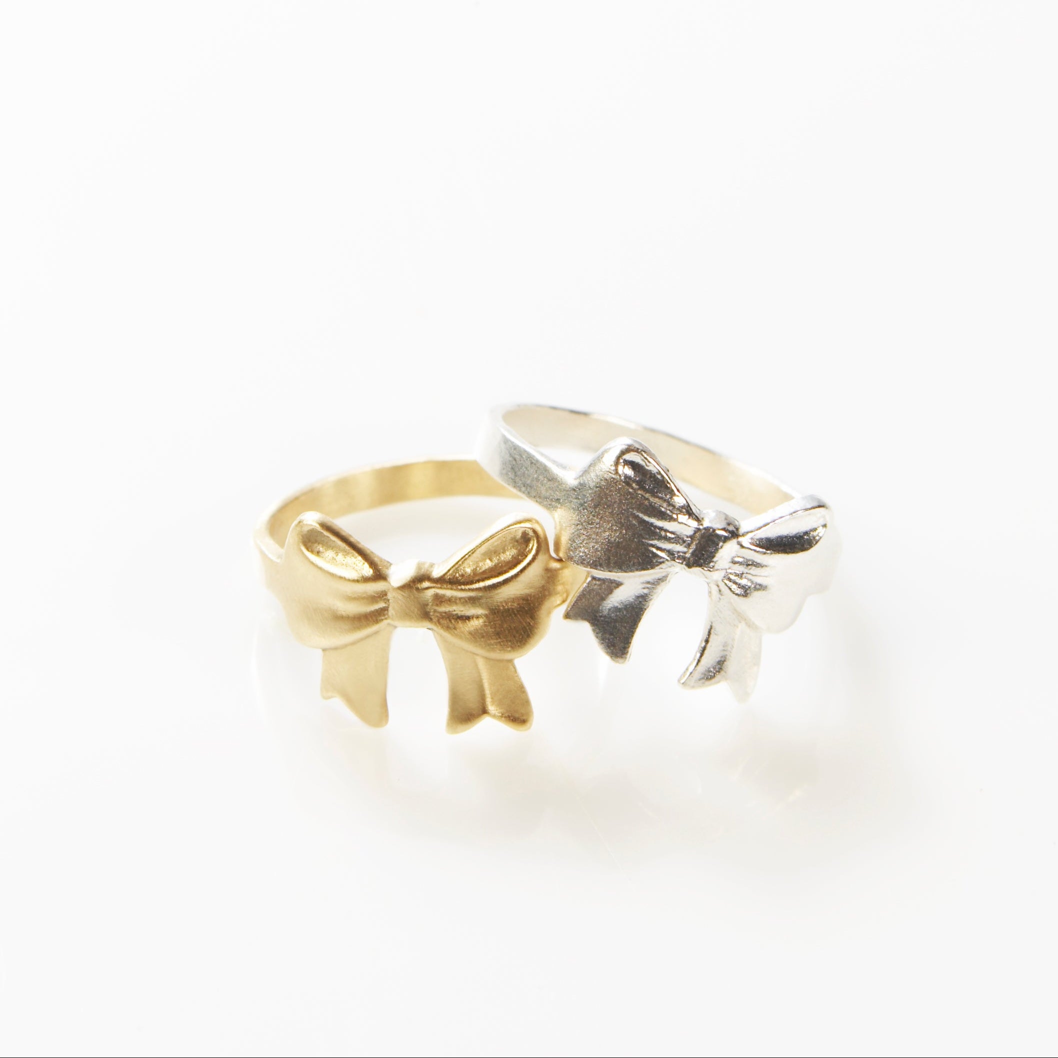 Gold and silver bow-shaped ring by maya geller
