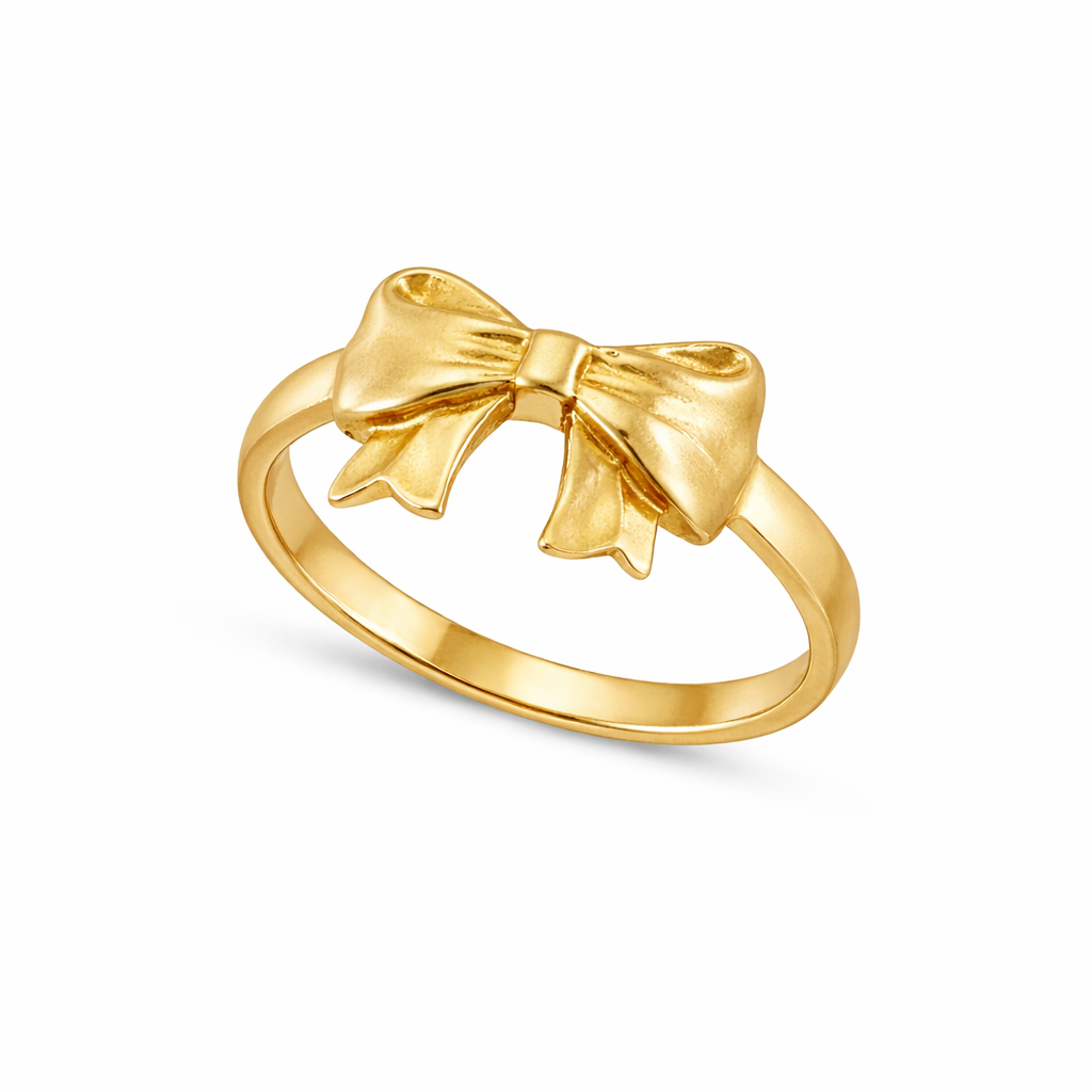 Gold bow-shaped ring on a white background