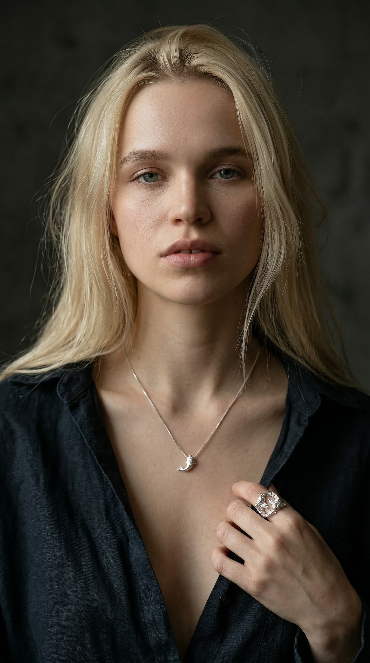a model is wearing koi fish necklace and koi fish ring by maya geller
