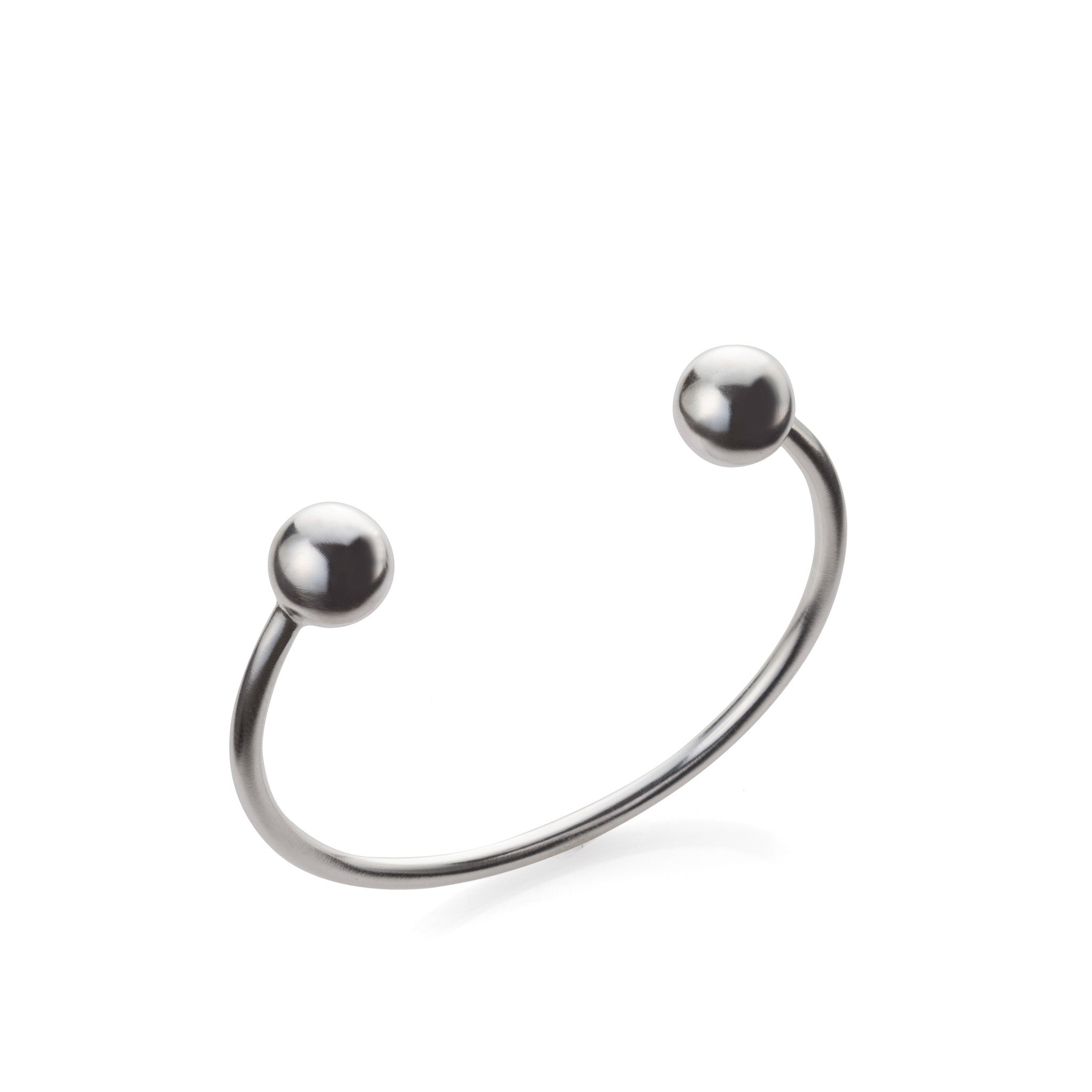 A silver open bracelet with two round beads and a metallic clasp.